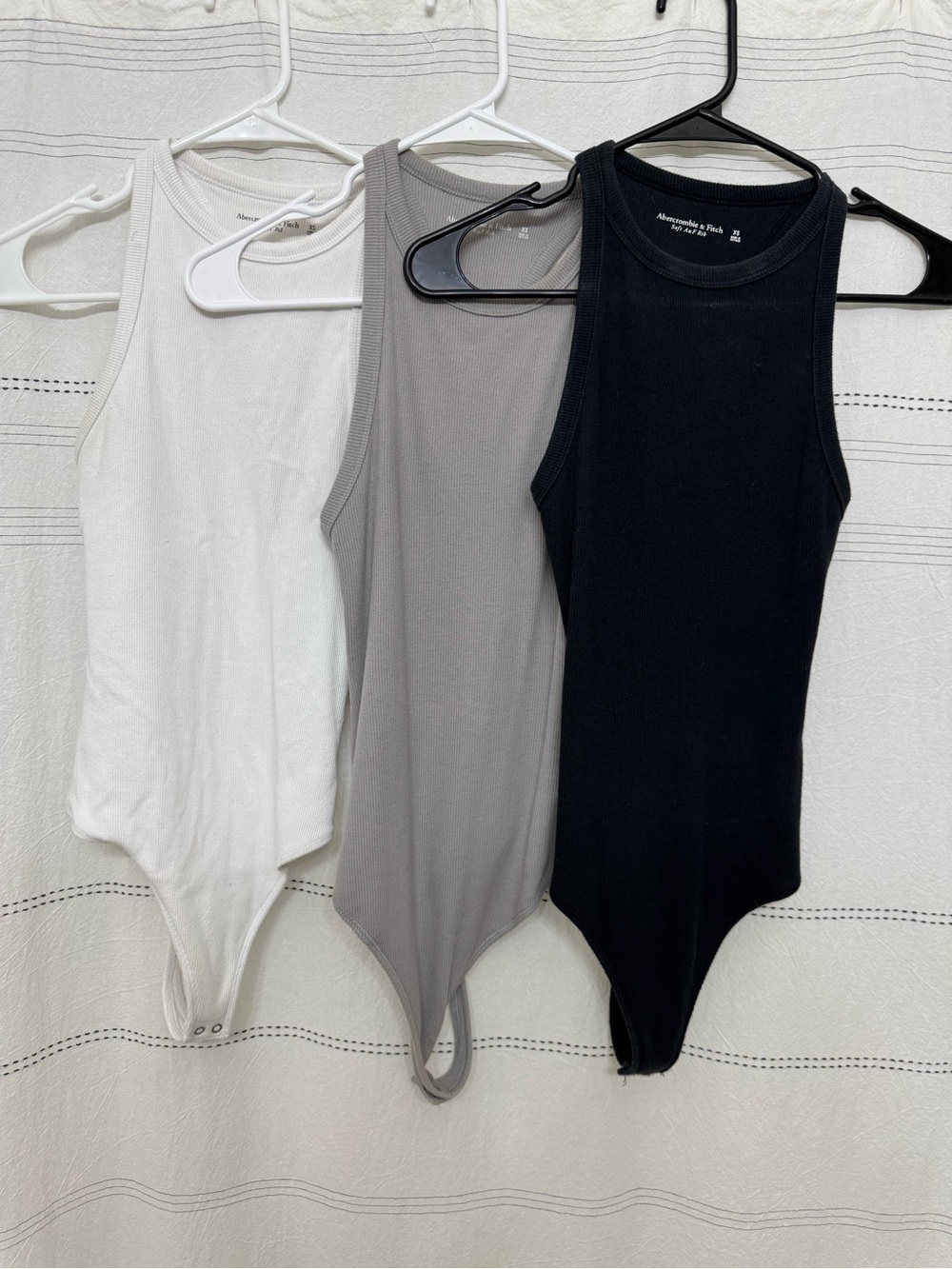 Abercrombie & Fitch Ribbed Tank Bodysuits in White, Gray, and Black